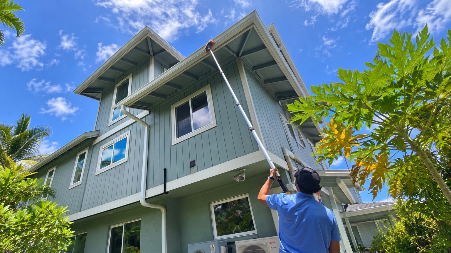 Technician cleaning roof exterior on an Oahu home